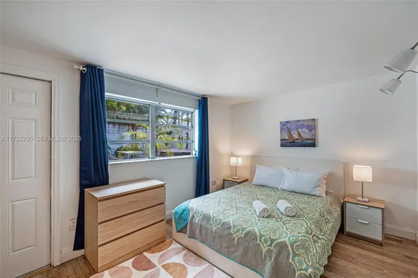 a bedroom with a large bed and a window