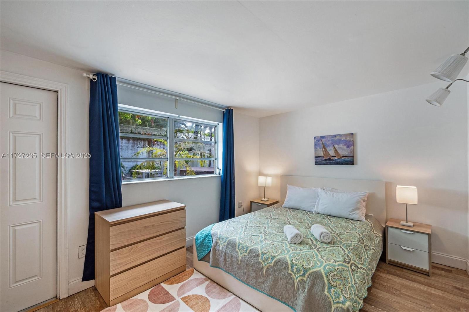 1428 Southwest 11th Terrace Miami, FL 33135 - Photo 24 of 36 a bedroom with a large bed and a window
