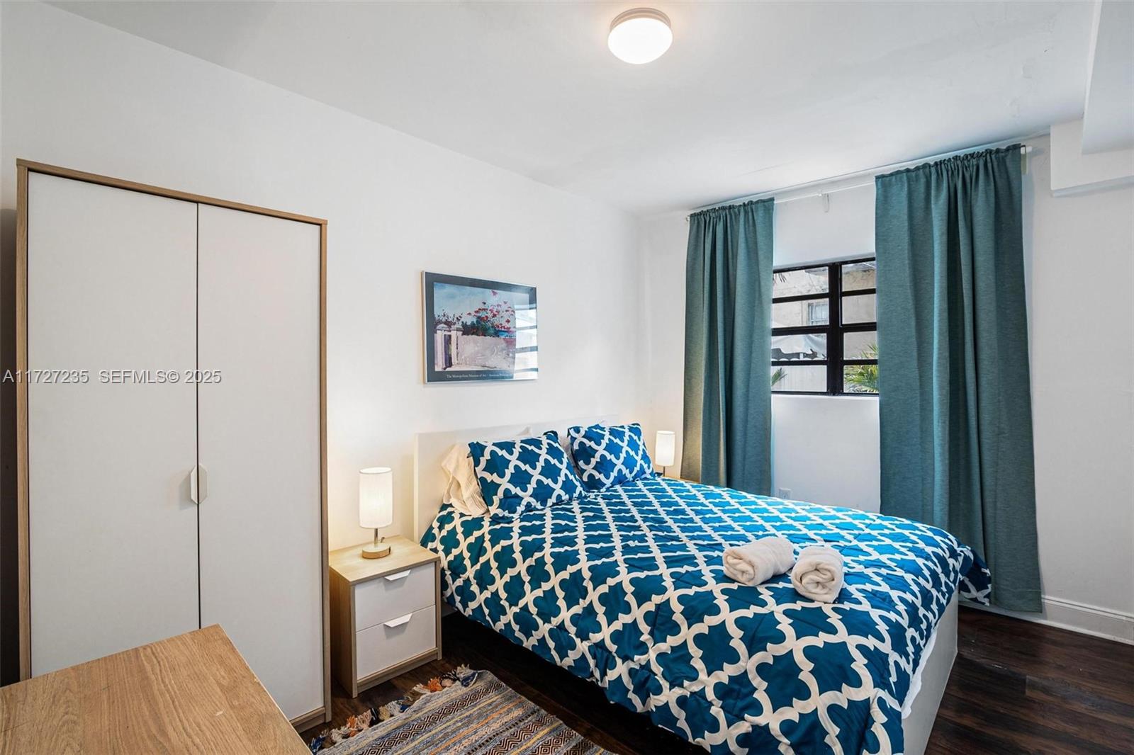 1428 Southwest 11th Terrace Miami, FL 33135 - Photo 26 of 36 a bedroom with a bed and wooden floor