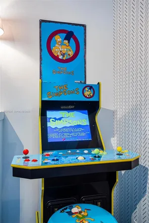 a room with painting on the wall and a table