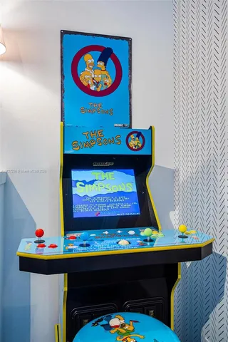 a room with painting on the wall and a table