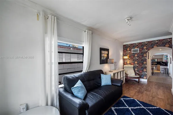 a living room with furniture and wooden floor