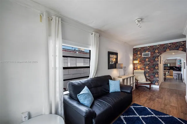 a living room with furniture and wooden floor