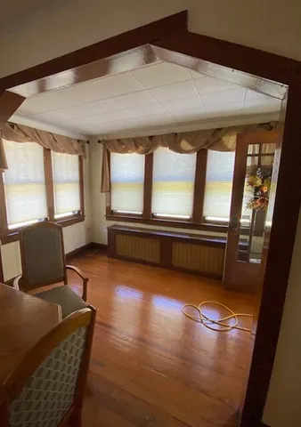 a living room with furniture and floor to ceiling windows