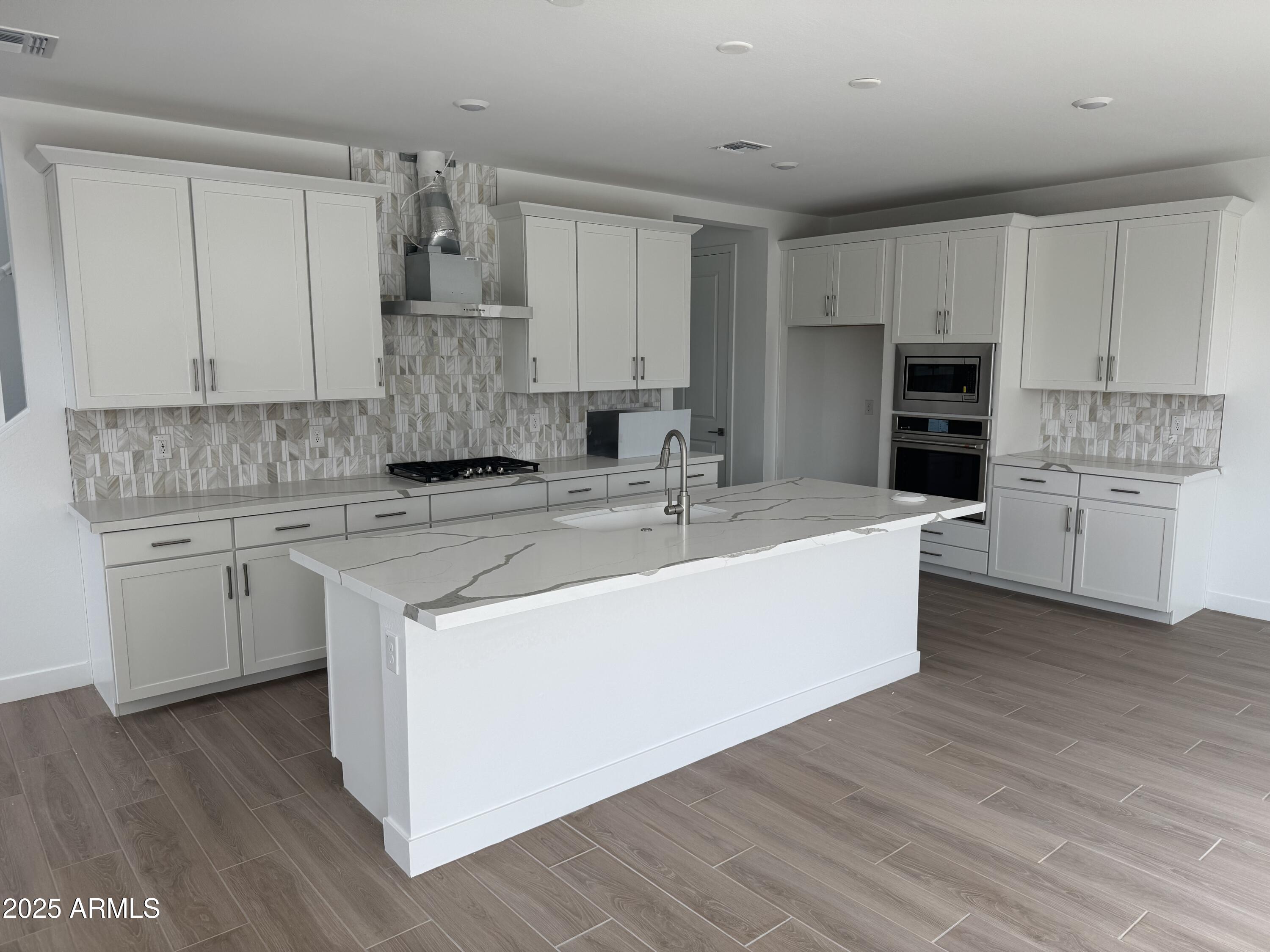 2464 West Rowel Road Phoenix, AZ 85085 - Photo 2 of 12 a kitchen with kitchen island granite countertop a sink cabinets and stainless steel appliances
