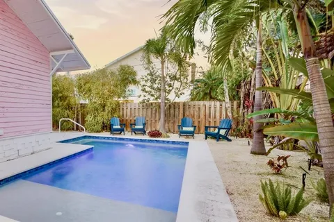 a backyard of a house with table and chairs