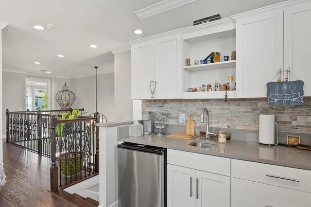a kitchen with stainless steel appliances granite countertop a sink a stove and cabinets