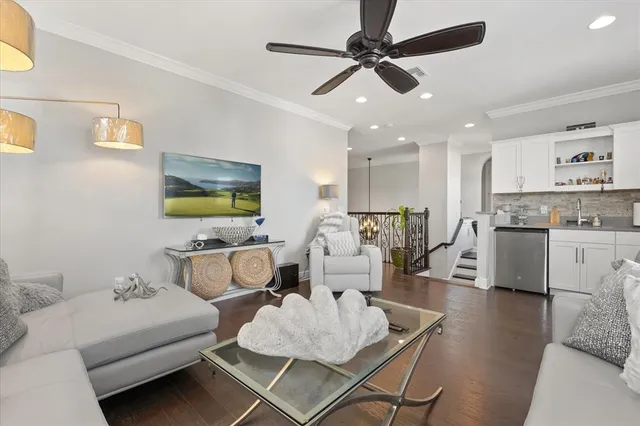 a living room with furniture kitchen view and a flat screen tv