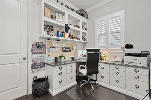 a view of a workspace with furniture and a window