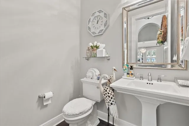 a bathroom with a toilet a sink and a mirror