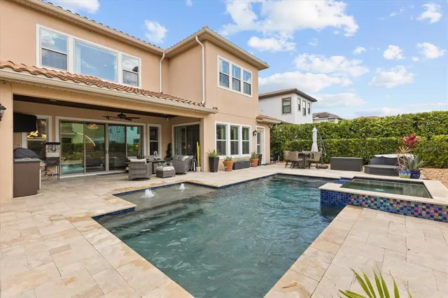 a view of a house with swimming pool and sitting area