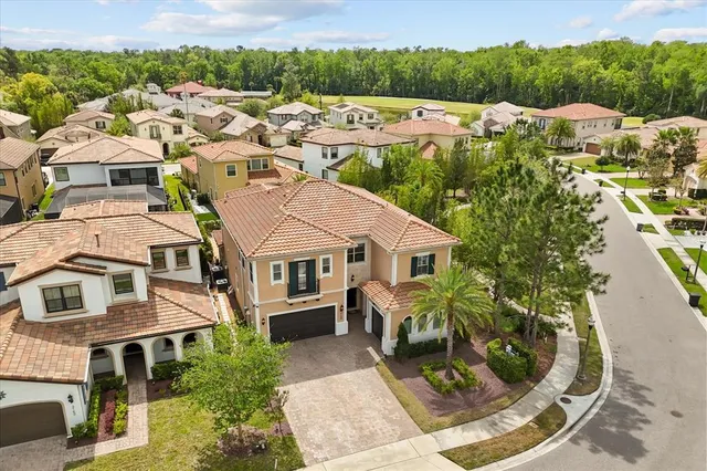 an aerial view of a house with a yard