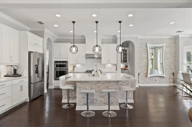 a large kitchen with a table and chairs