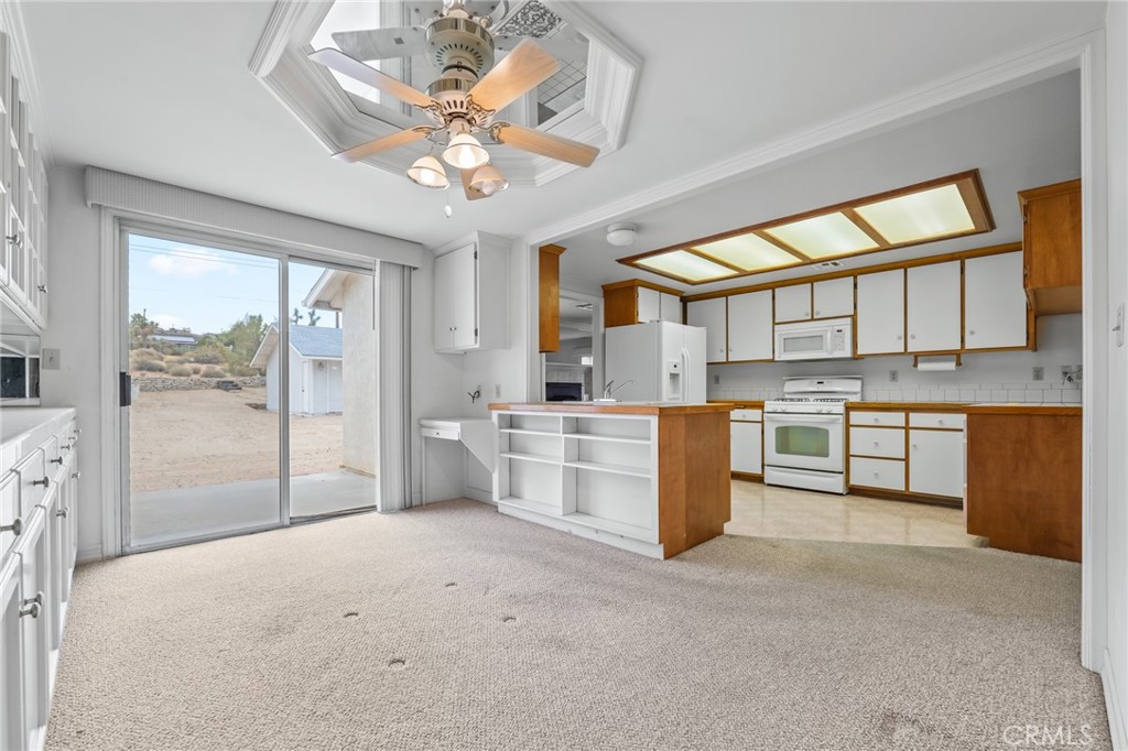57622 Sierra Way Yucca Valley, CA 92284 - Photo 13 of 55 a large white kitchen with a large window