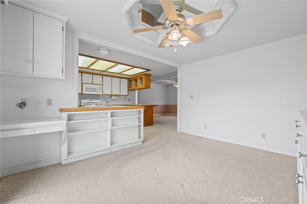 57622 Sierra Way Yucca Valley, CA 92284 - Photo 14 of 55 a room with a chandelier fan and a large window