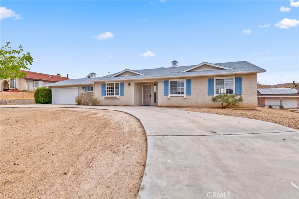 57622 Sierra Way Yucca Valley, CA 92284 - Photo 2 of 55 a front view of a house with a yard and potted plants