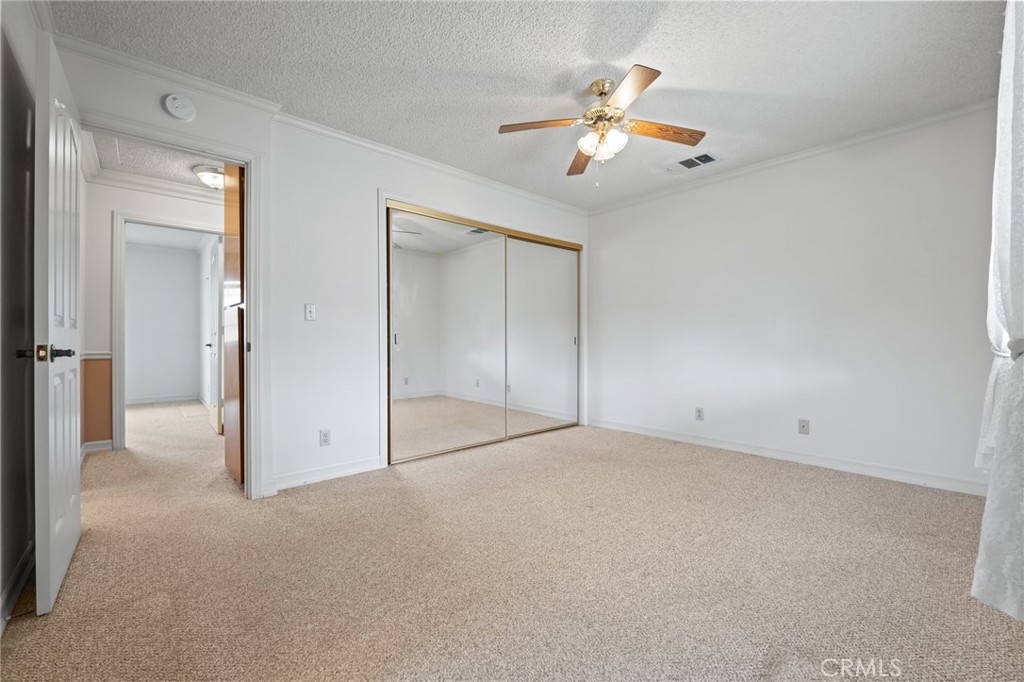 57622 Sierra Way Yucca Valley, CA 92284 - Photo 22 of 55 an empty room with chandelier fan and windows