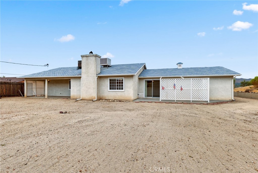 57622 Sierra Way Yucca Valley, CA 92284 - Photo 33 of 55 front view of a house with a wooden fence