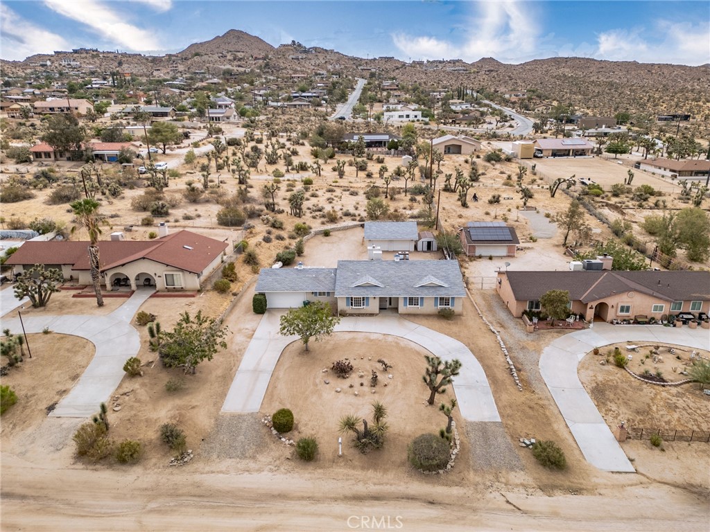 57622 Sierra Way Yucca Valley, CA 92284 - Photo 40 of 55 an aerial view of a swimming pool and mountain view