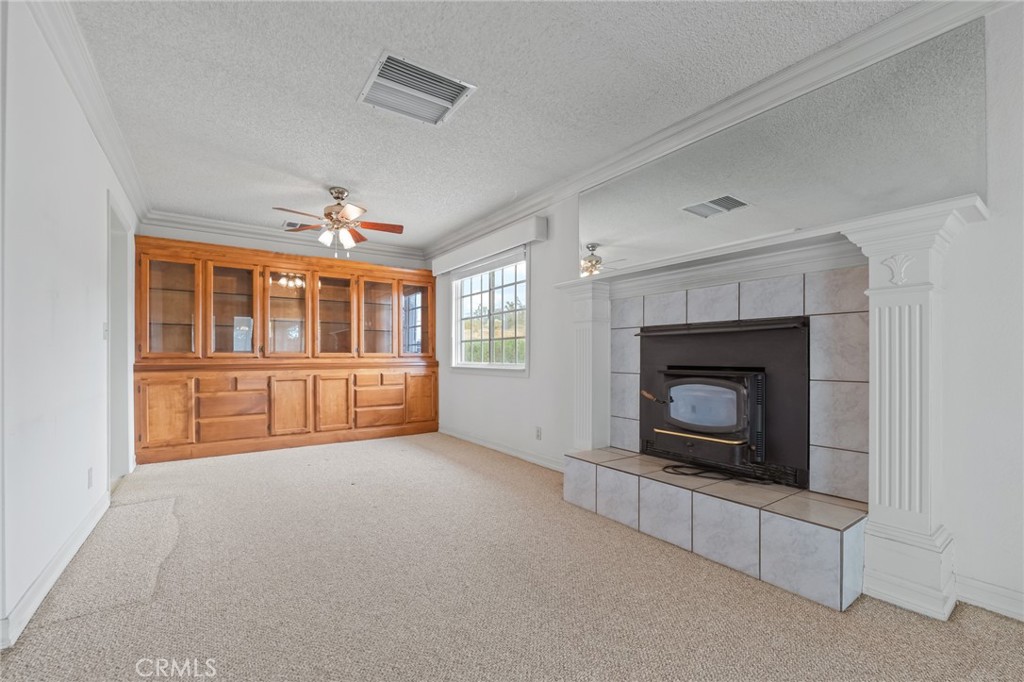 57622 Sierra Way Yucca Valley, CA 92284 - Photo 8 of 55 an empty room with windows and fireplace