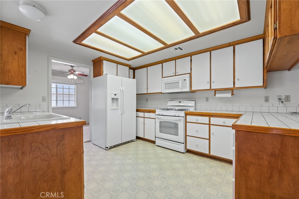 57622 Sierra Way Yucca Valley, CA 92284 - Photo 9 of 55 a kitchen with stainless steel appliances granite countertop a stove a sink dishwasher and a refrigerator