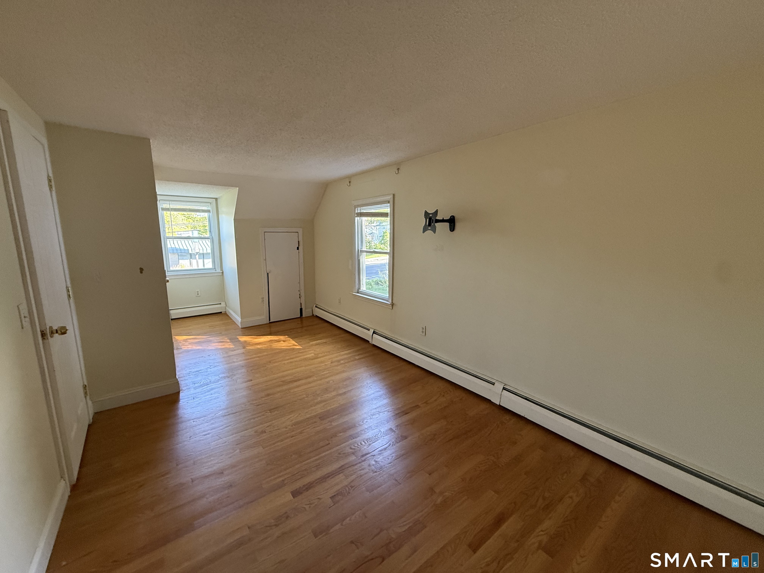 808 East Main Street Torrington, CT 06790 - Photo 35 of 40 an empty room with wooden floor and windows