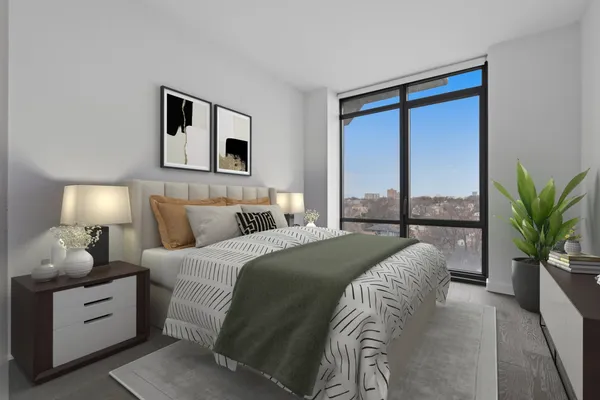a bedroom with a large bed and a potted plant