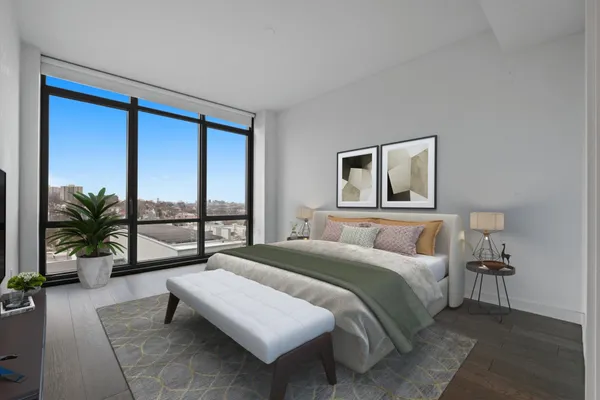 a bedroom with a large bed and a large window