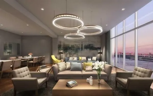 a living room with furniture a fireplace and a large window