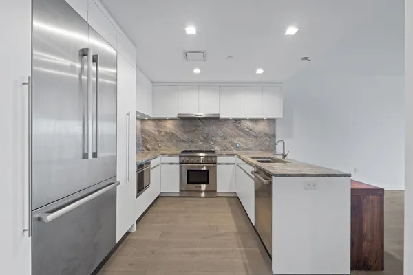 a kitchen with a stove and a refrigerator
