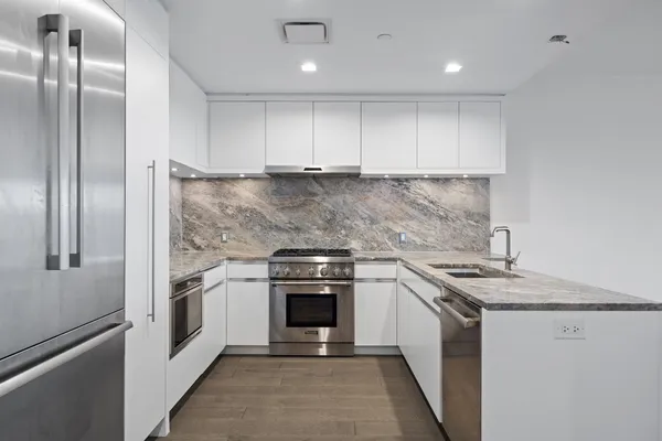 a kitchen with cabinets stainless steel appliances and a counter top