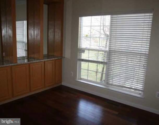 18421 Crestmount Road Boyds, MD 20841 - Photo 5 of 13 an empty room with wooden floor and windows