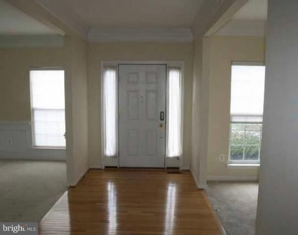 18421 Crestmount Road Boyds, MD 20841 - Photo 8 of 13 an empty room with wooden floor and windows