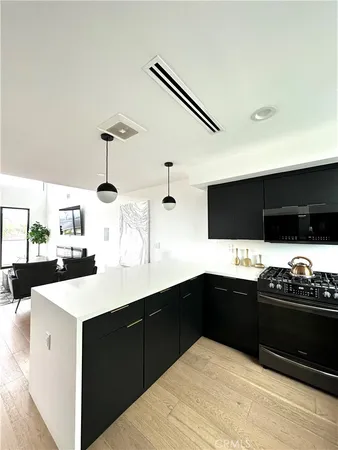 a kitchen with a sink and white cabinets