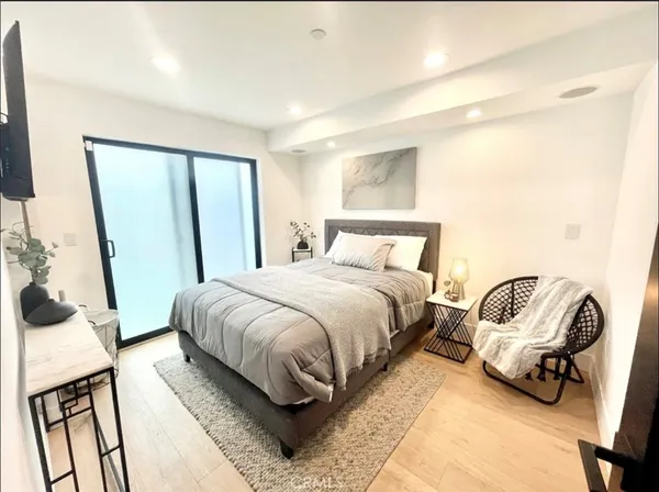 a bed room with a bed and a chair