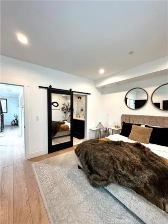 a bedroom with a large bed and a large mirror