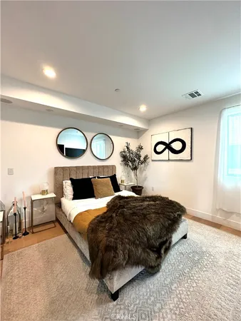 a bedroom with double bed and a large mirror
