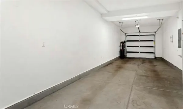 an empty room with a ceiling fan and window