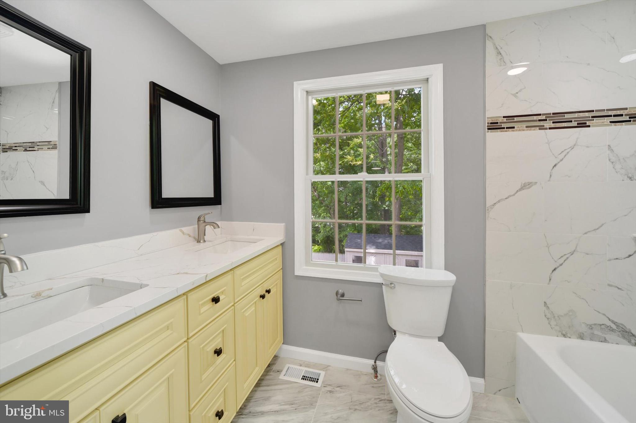 220 Sandhill Road Baltimore, MD 21221 - Photo 14 of 30 a bathroom with a toilet sink and mirror