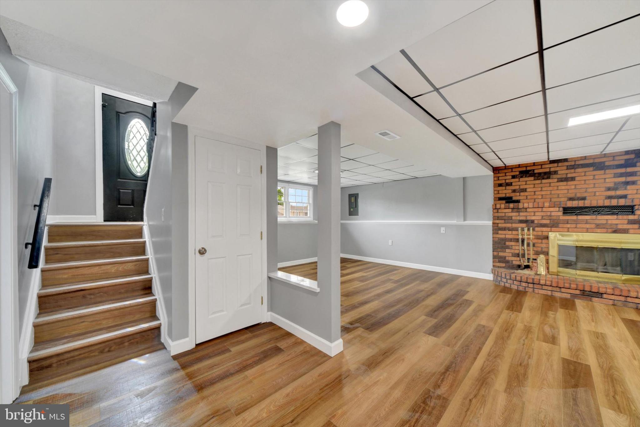 220 Sandhill Road Baltimore, MD 21221 - Photo 16 of 30 a view of an empty room with wooden floor and a window
