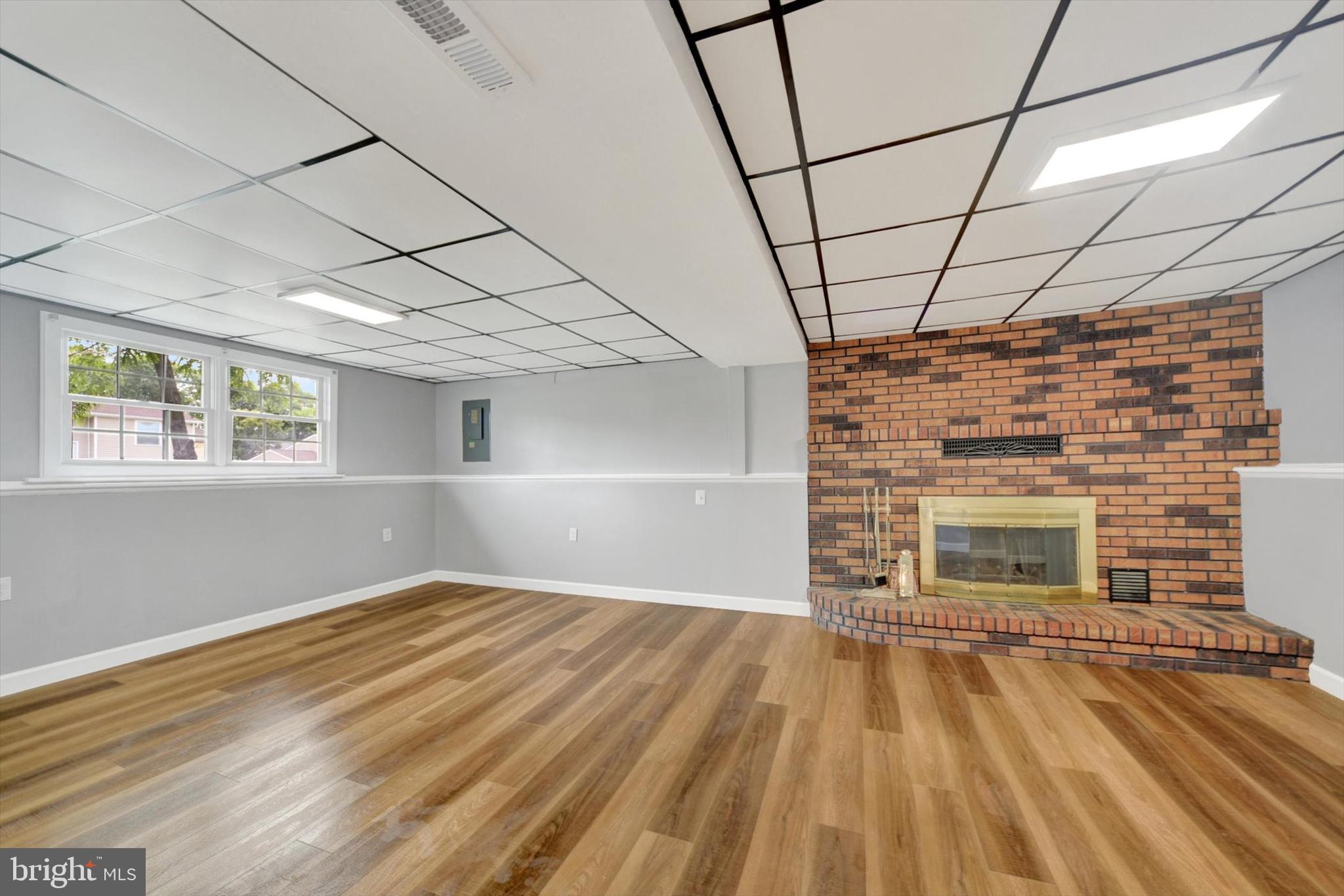220 Sandhill Road Baltimore, MD 21221 - Photo 17 of 30 a view of empty room with wooden floor and fireplace