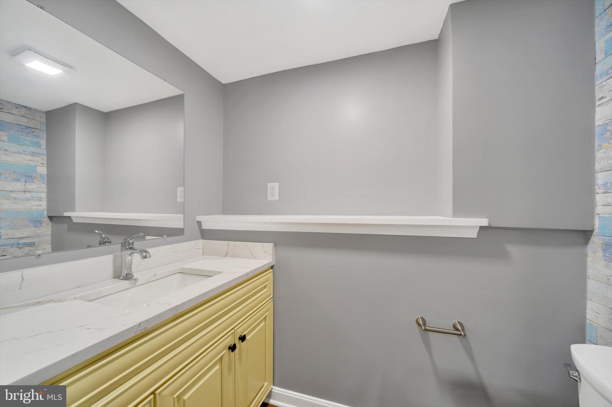 220 Sandhill Road Baltimore, MD 21221 - Photo 19 of 30 a bathroom with a sink a toilet and a mirror