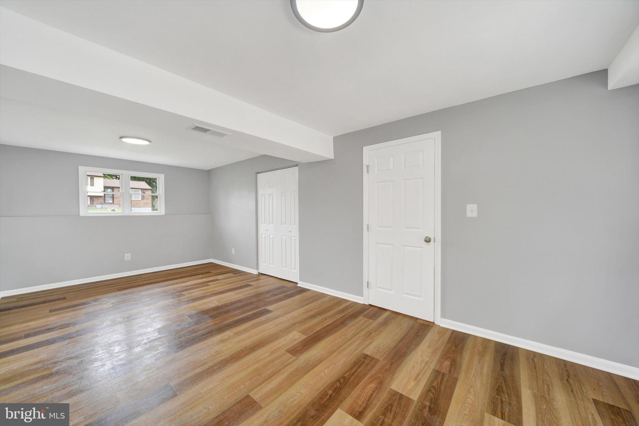 220 Sandhill Road Baltimore, MD 21221 - Photo 22 of 30 a view of empty room with wooden floor