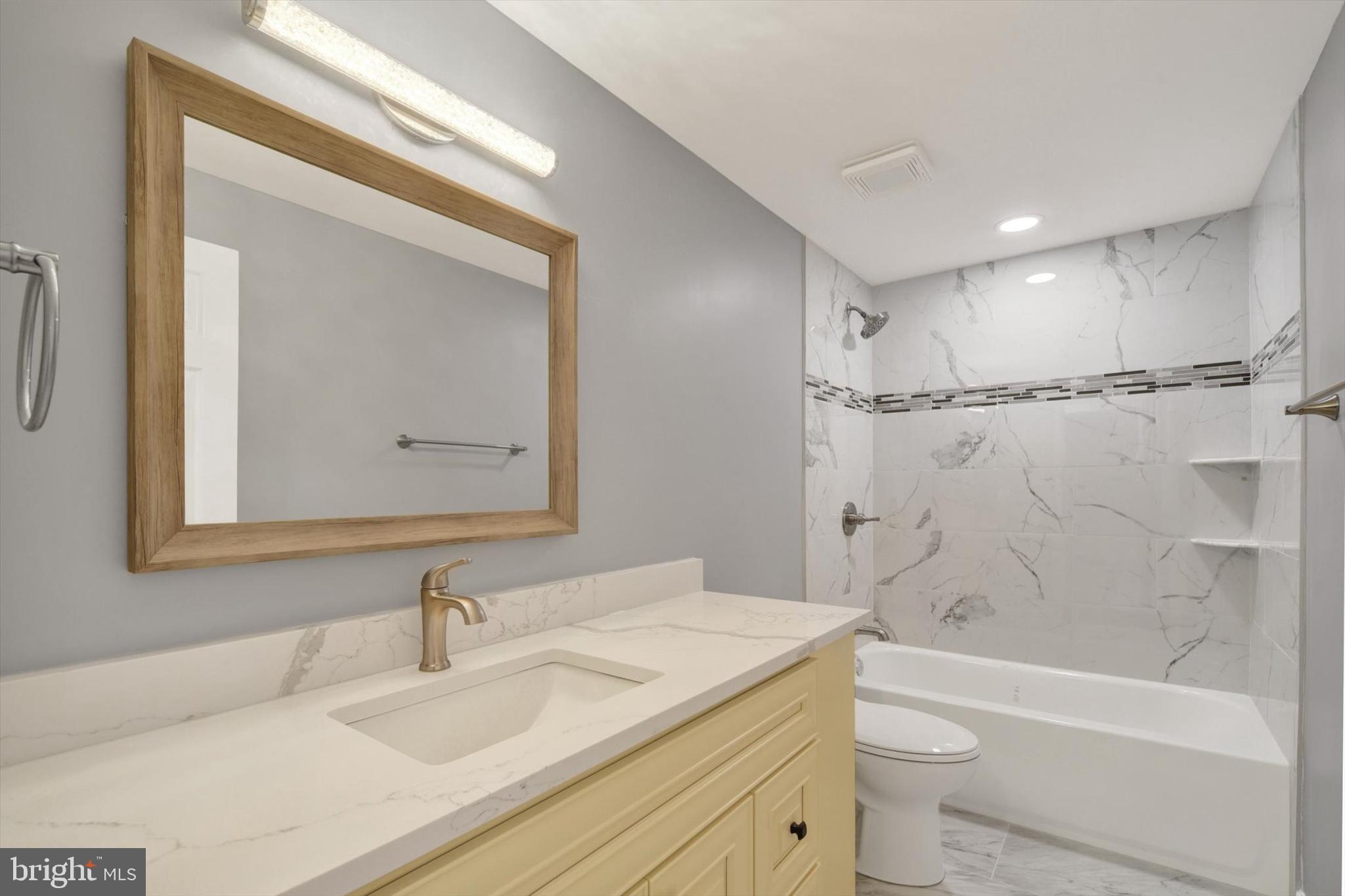 220 Sandhill Road Baltimore, MD 21221 - Photo 10 of 30 a bathroom with a bathtub shower sink vanity mirror and toilet