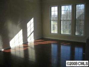 1102 Drayton Court, Unit 2002 Fort Mill, SC 29708 - Photo 3 of 4 a view of an empty room with wooden floor and a window