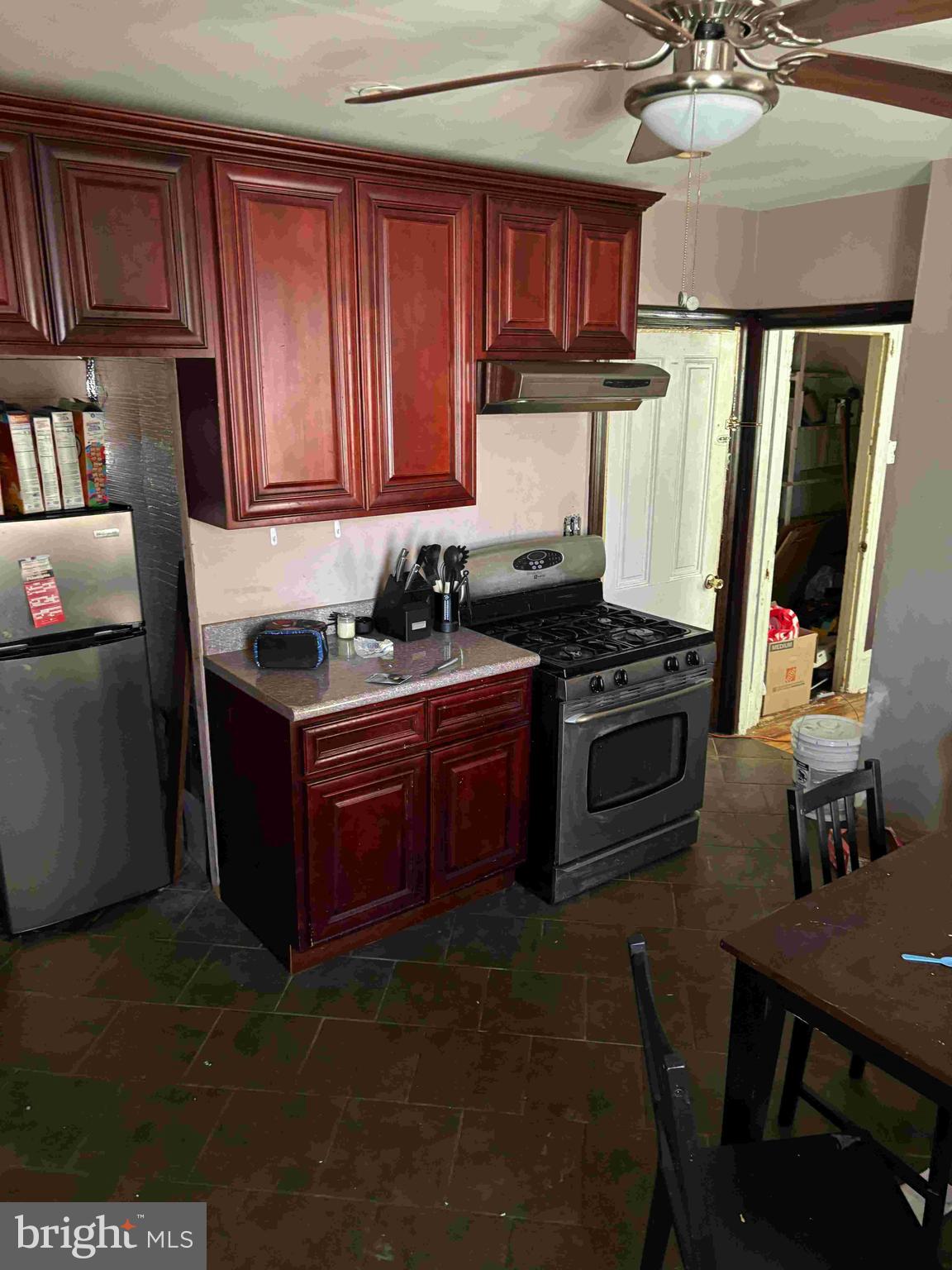 6740 Keystone Street Philadelphia, PA 19135 - Photo 13 of 14 a kitchen with stainless steel appliances a stove a sink dishwasher and cabinets with wooden floor