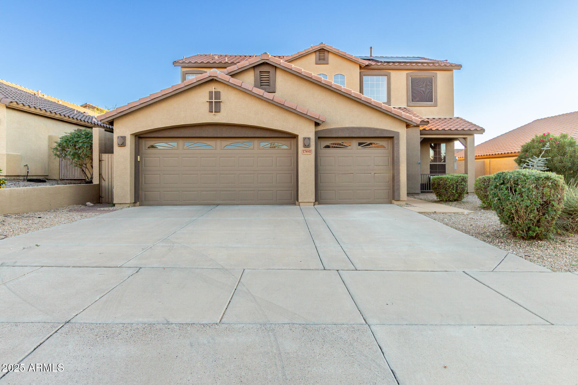 a front view of a house with a garage and balcony