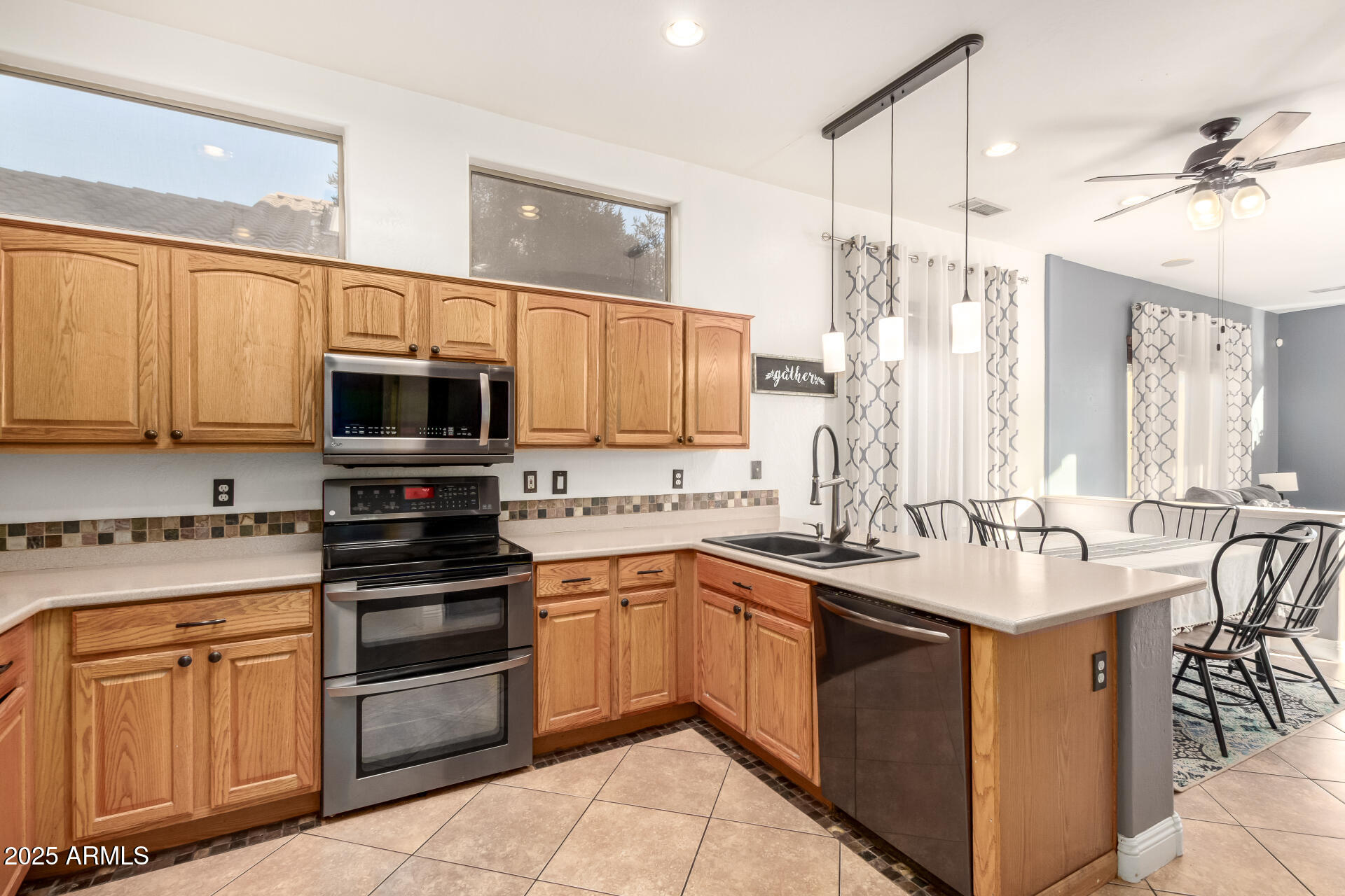 17441 West Arroyo Way Goodyear, AZ 85338 - Photo 11 of 27 a kitchen with stainless steel appliances granite countertop a sink stove and microwave