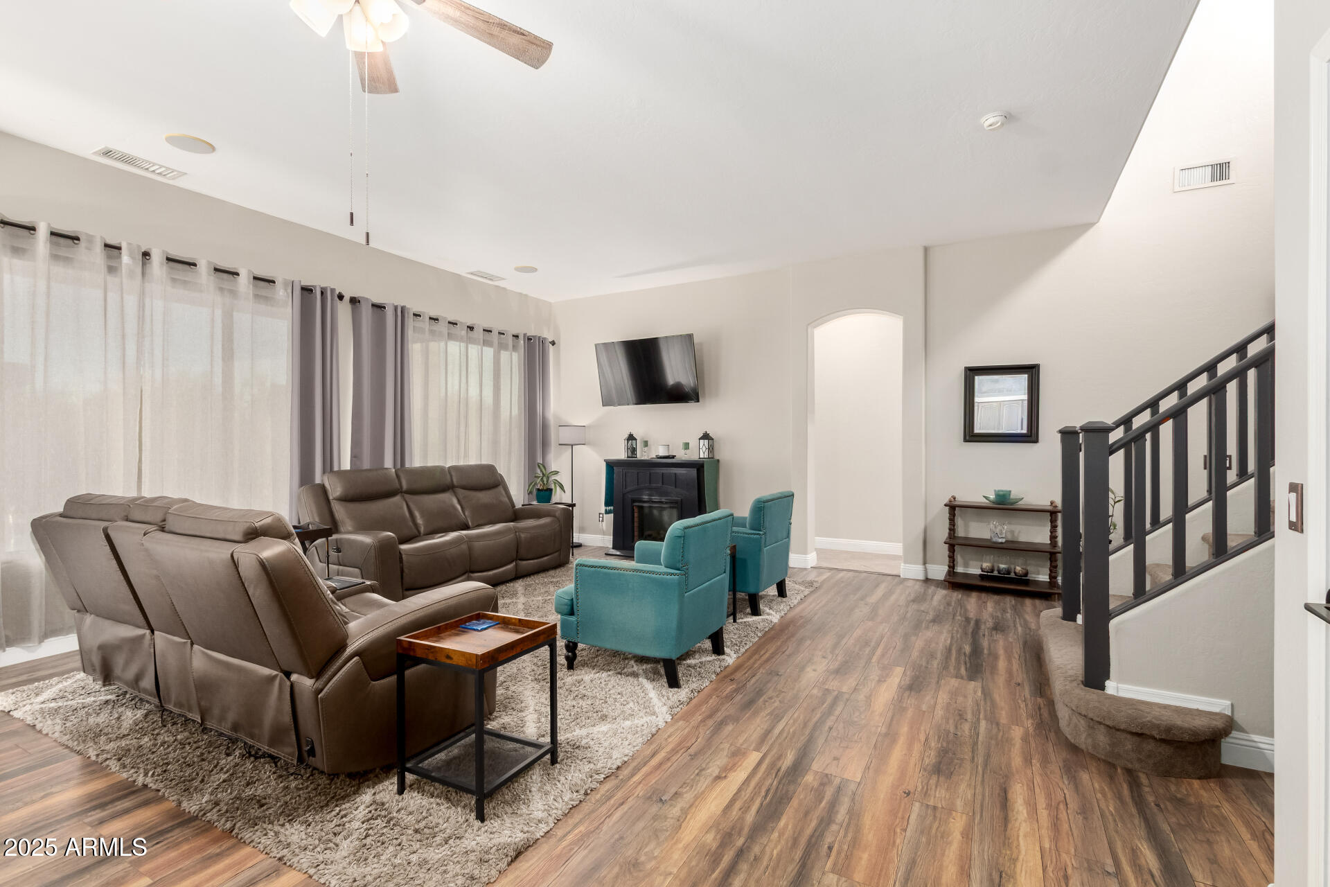17441 West Arroyo Way Goodyear, AZ 85338 - Photo 14 of 27 a living room with furniture and a wooden floor