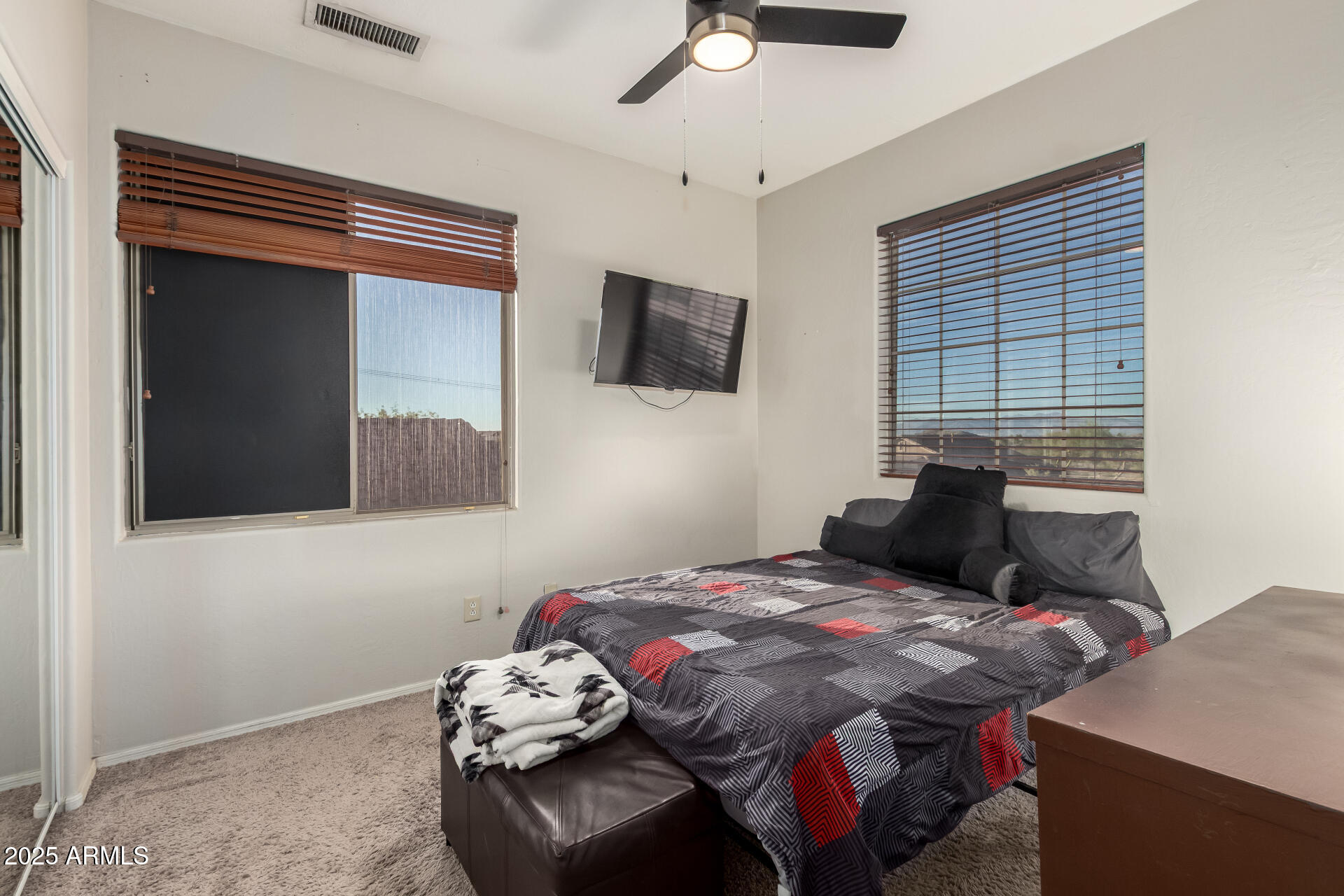 17441 West Arroyo Way Goodyear, AZ 85338 - Photo 20 of 27 a bedroom with a bed and flat screen tv
